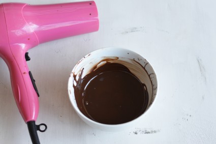 Melted chocolate in bowl next to hair dryer